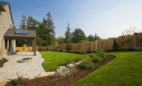 A finished timber garden fence beside a patio